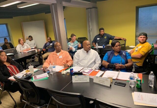 Contractors with course materials at tables during a DBE Bonding Series class