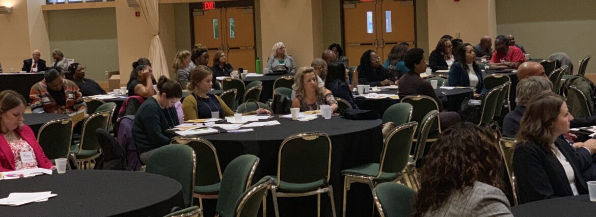 Attendees seated at round tables during an economic development event