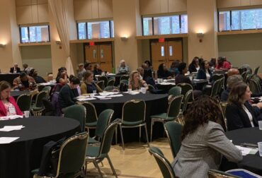 Attendees seated at round tables during an economic development event