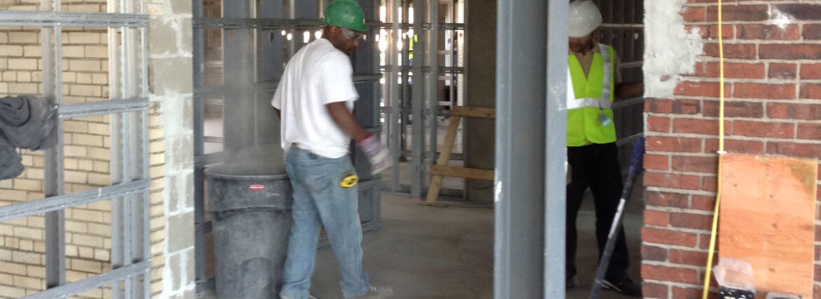 Construction worker in a safety vest at a building site